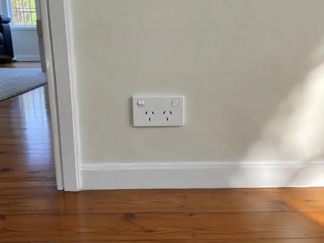 White double power point on a painted internal wall with timber floorboards in Old Toongabbie